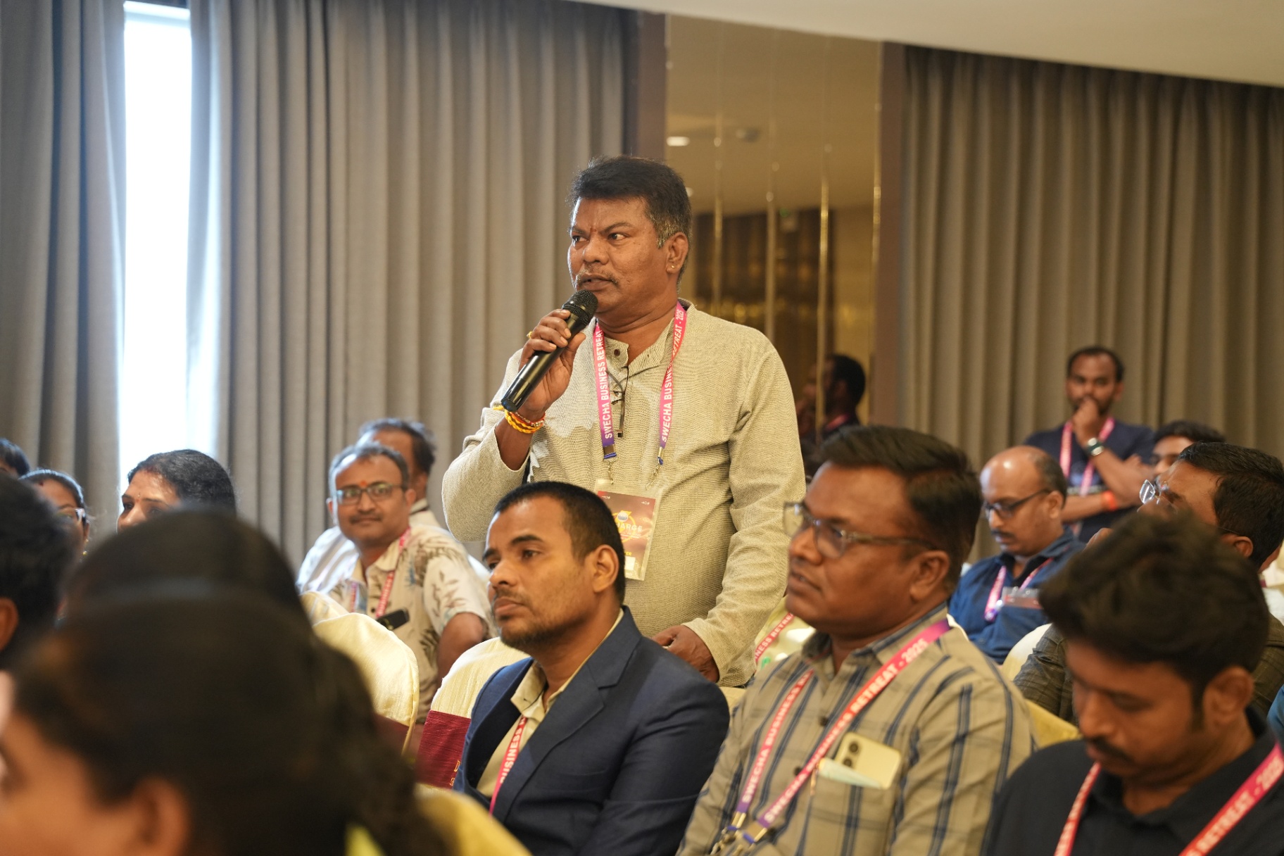 Engaged attendee asking a question